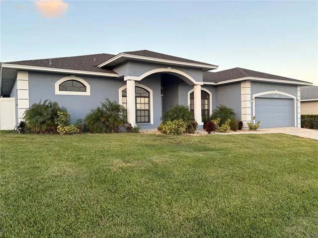 a front view of house with yard and green space