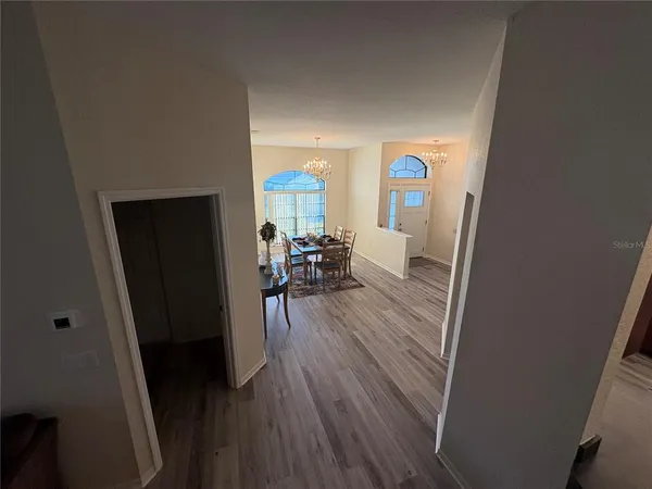 a view of a room with wooden floor and furniture