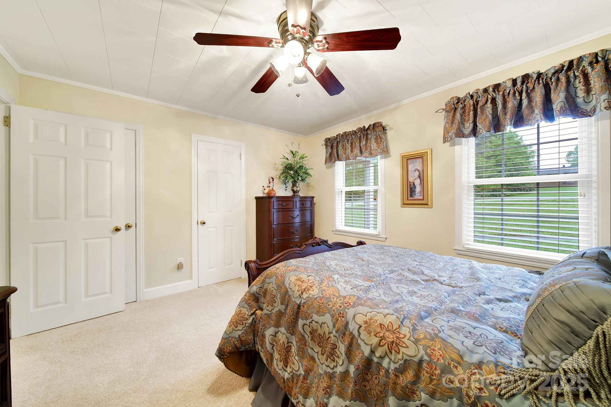 4462 Flat Creek Road Lancaster, SC 29720 - Photo 13 of 35 a bed sitting in a spacious bedroom next to a window and a chandelier