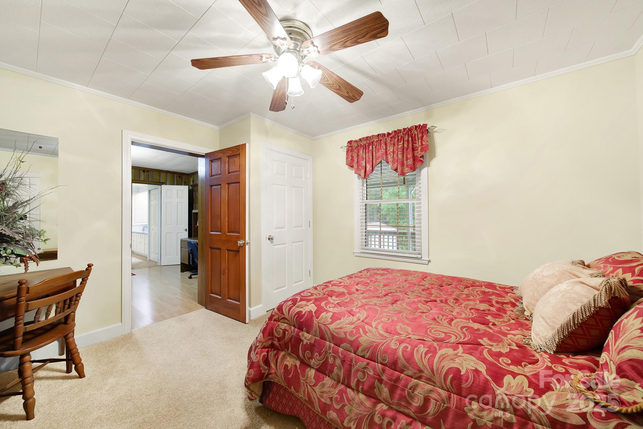 4462 Flat Creek Road Lancaster, SC 29720 - Photo 15 of 35 a bedroom with a bed and a chandelier