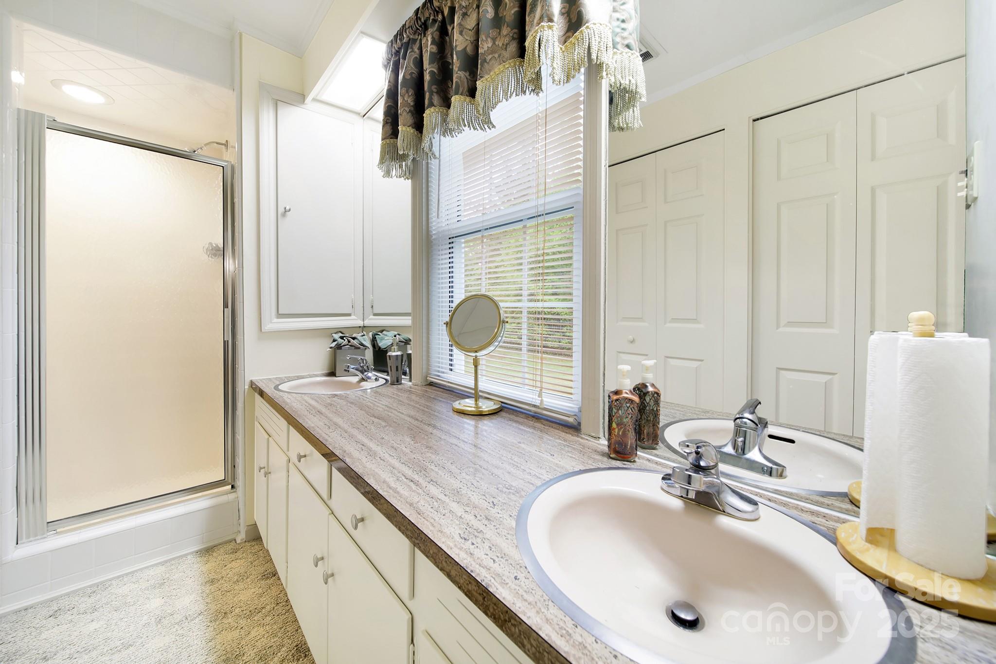 4462 Flat Creek Road Lancaster, SC 29720 - Photo 19 of 35 a bathroom with a double vanity sink and a mirror