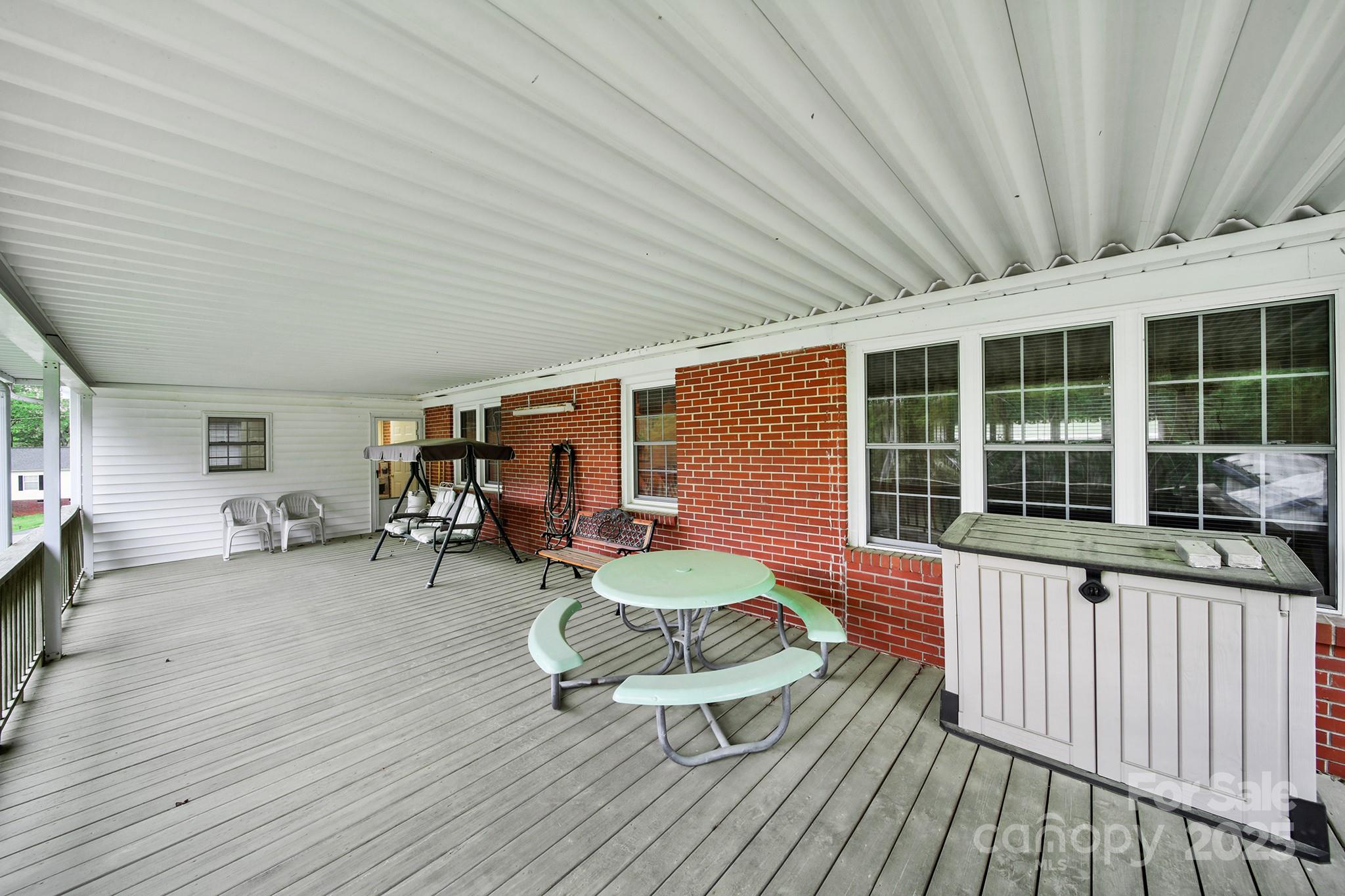 4462 Flat Creek Road Lancaster, SC 29720 - Photo 26 of 35 a view of a patio with table and chairs with wooden floor and fence