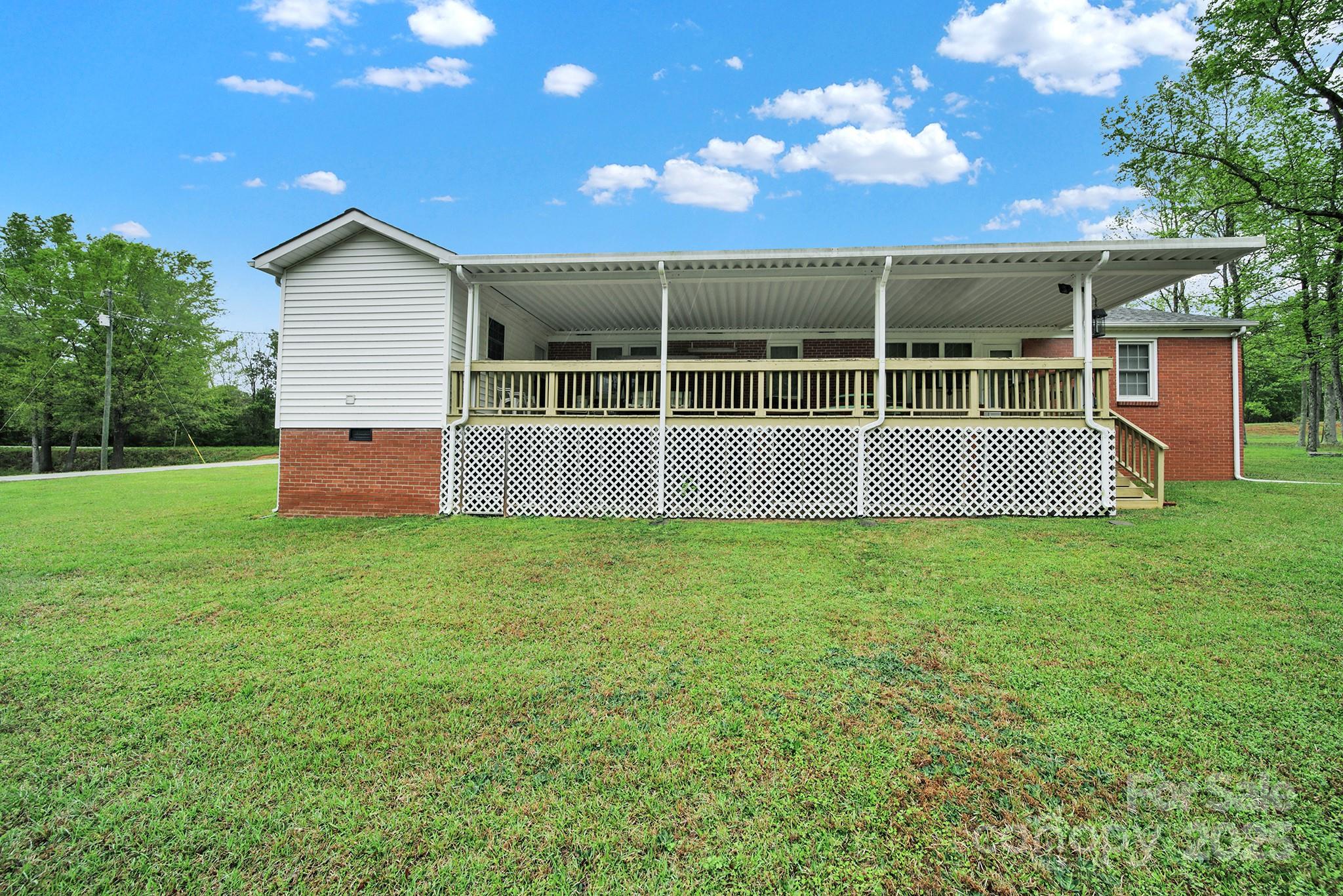 4462 Flat Creek Road Lancaster, SC 29720 - Photo 28 of 35 a backyard of a house with lots of green space and garden