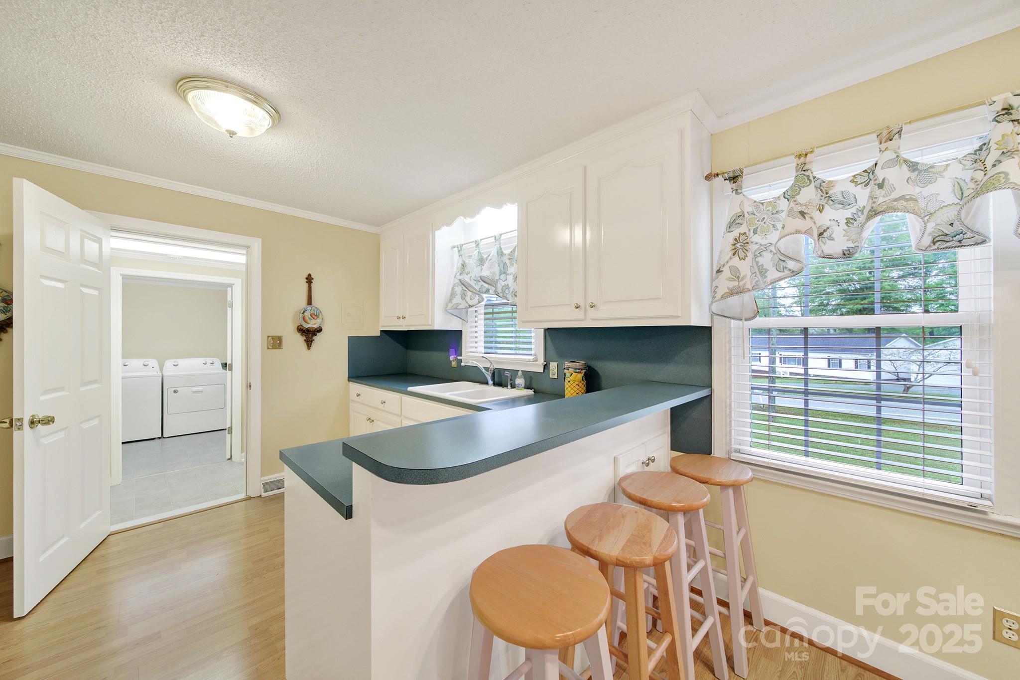 4462 Flat Creek Road Lancaster, SC 29720 - Photo 8 of 35 a large kitchen with granite countertop a sink and a refrigerator