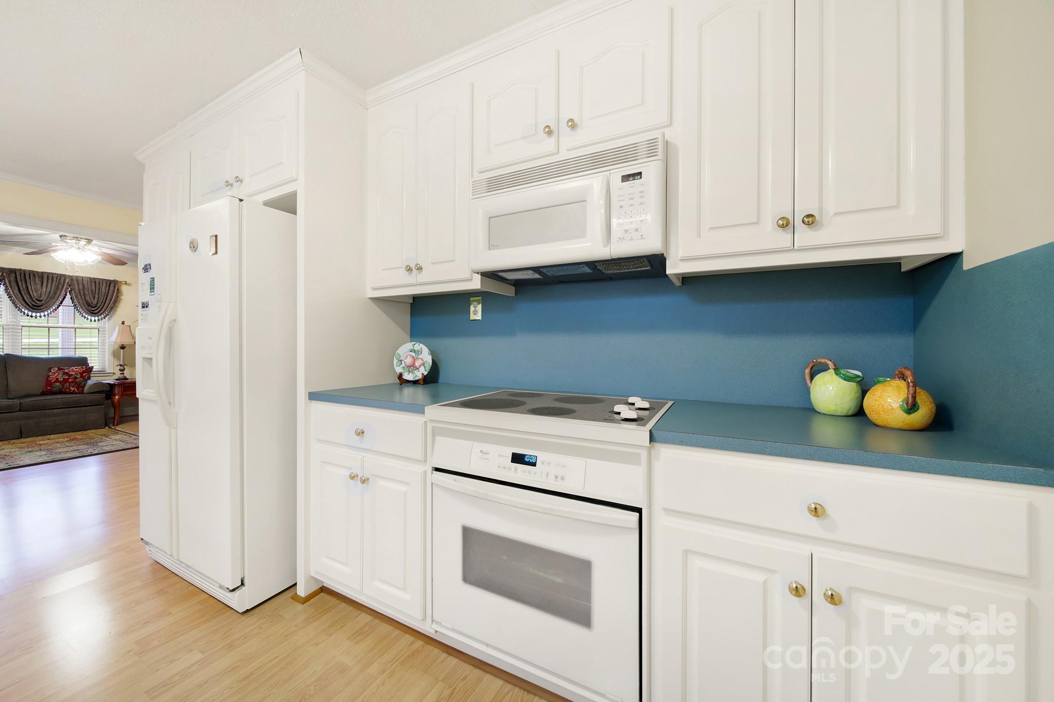 4462 Flat Creek Road Lancaster, SC 29720 - Photo 9 of 35 a kitchen with granite countertop white cabinets and white appliances