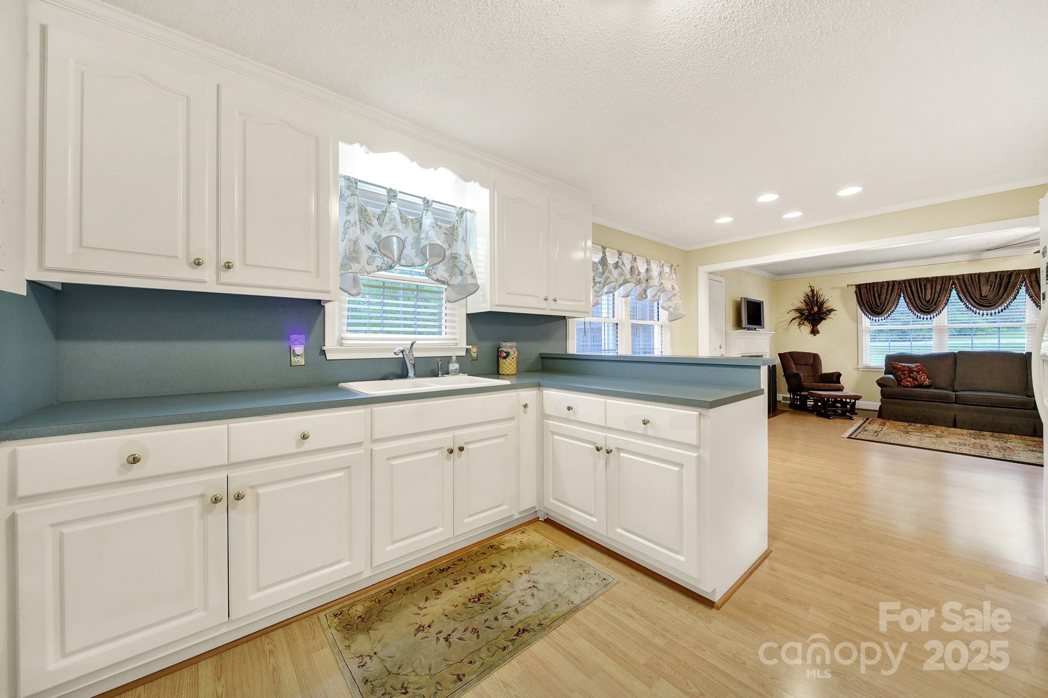 4462 Flat Creek Road Lancaster, SC 29720 - Photo 10 of 35 a kitchen with granite countertop white cabinets and white appliances