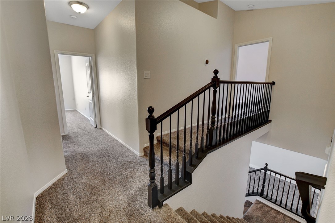 191 Verde Ridge Court Henderson, NV 89012 - Photo 18 of 36 Staircase with carpet flooring and baseboards