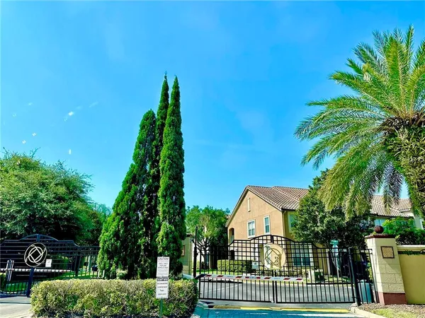 a view of house with a yard and potted plants