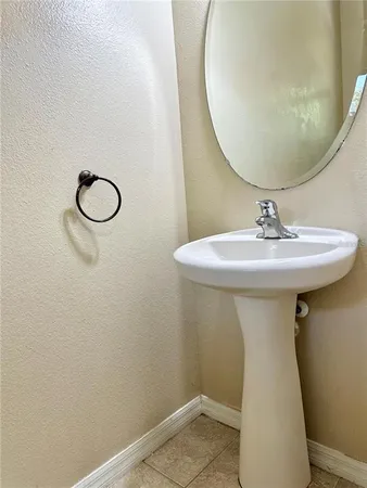 a bathroom with a sink and mirror