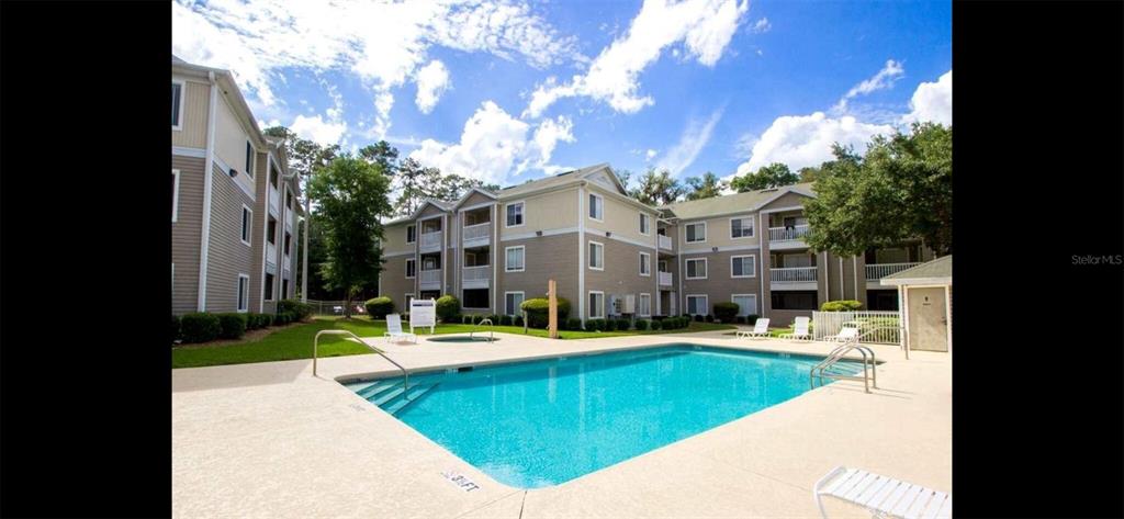 4000 Southwest 23rd Street, Unit 4103 #4 Gainesville, FL 32608 - Photo 11 of 17 a swimming pool with outdoor seating and yard