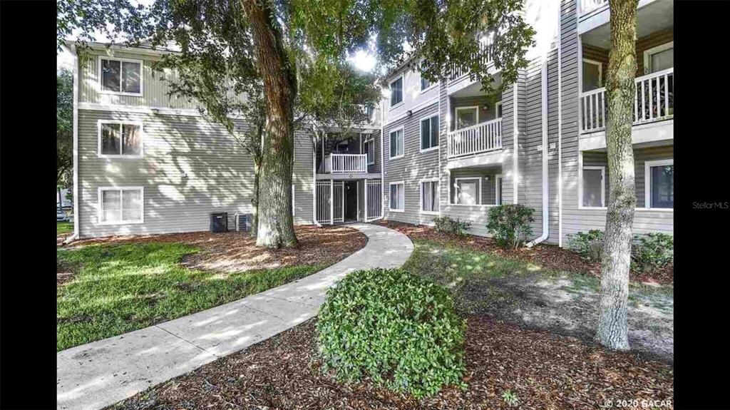 4000 Southwest 23rd Street, Unit 4103 #4 Gainesville, FL 32608 - Photo 12 of 17 a view of a building with a yard