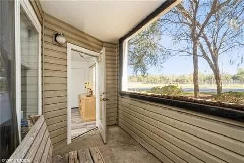 4000 Southwest 23rd Street, Unit 4103 Gainesville, FL 32608 - Photo 12 of 14 a view of a balcony with furniture and wooden floor