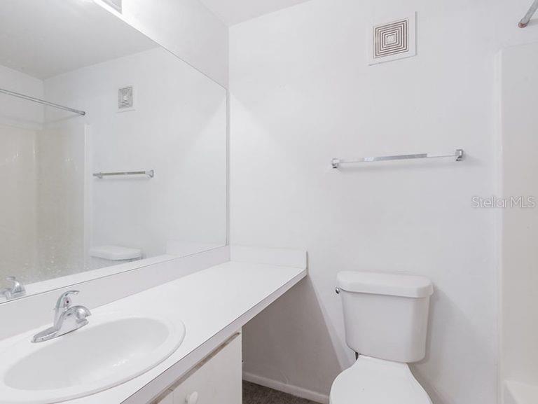 4000 Southwest 23rd Street, Unit 4103 #4 Gainesville, FL 32608 - Photo 8 of 17 a white toilet sitting next to a bathroom sink