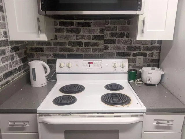 a kitchen with a stove and a microwave