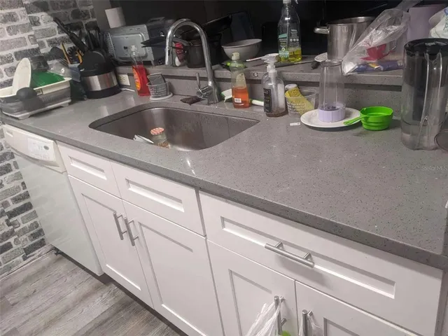 a kitchen with sink and a white stove