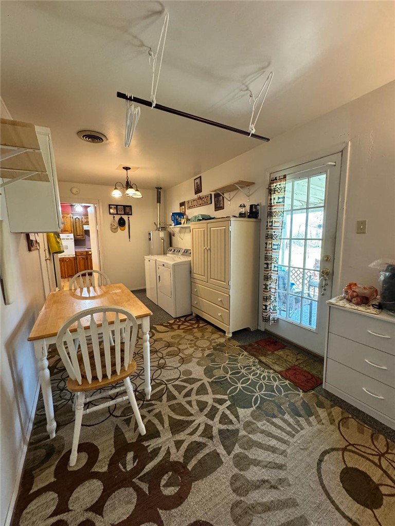 915 Maple Shade Road Alma, AR 72921 - Photo 15 of 18 Dining area featuring washing machine and clothes dryer and water heater