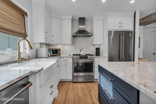a kitchen with stainless steel appliances a sink a stove and a window