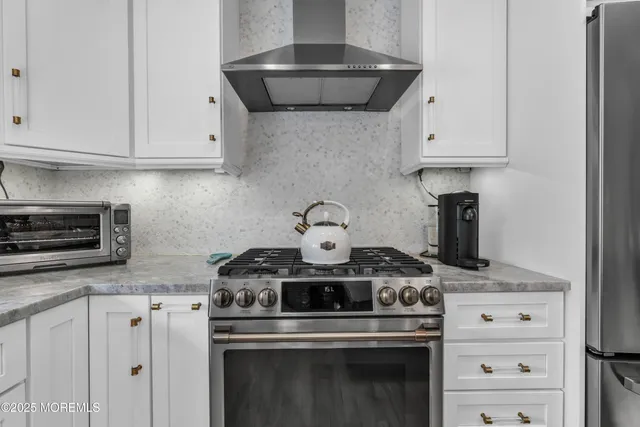 a view of a dining room with furniture a chandelier and wooden floor
