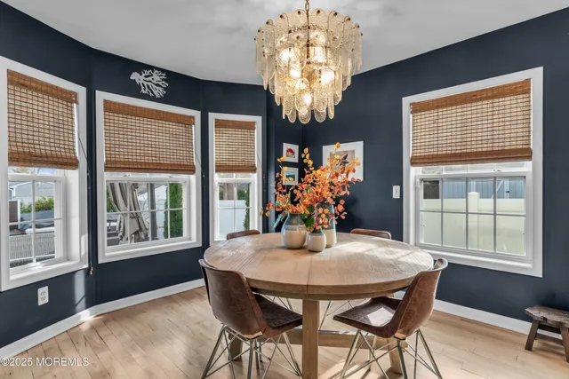 a view of a dining room with furniture and chandelier