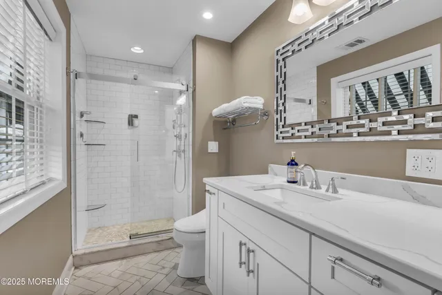 a spacious bedroom with a bed and window