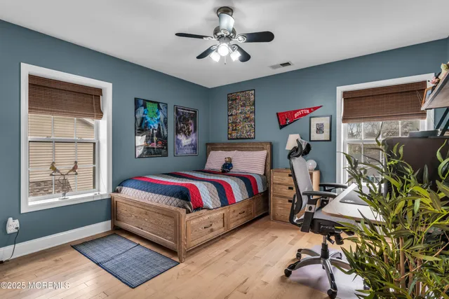 a living room with furniture a flat screen tv and a window