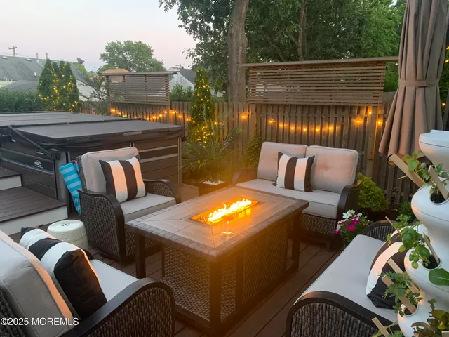 a view of a balcony with furniture and a potted plant
