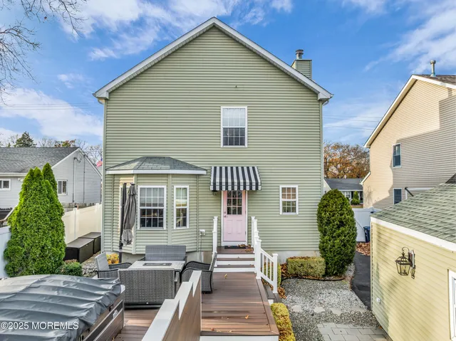 a view of a patio with table and chairs under an umbrella