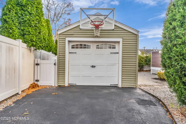 an aerial view of residential houses with outdoor space and parking