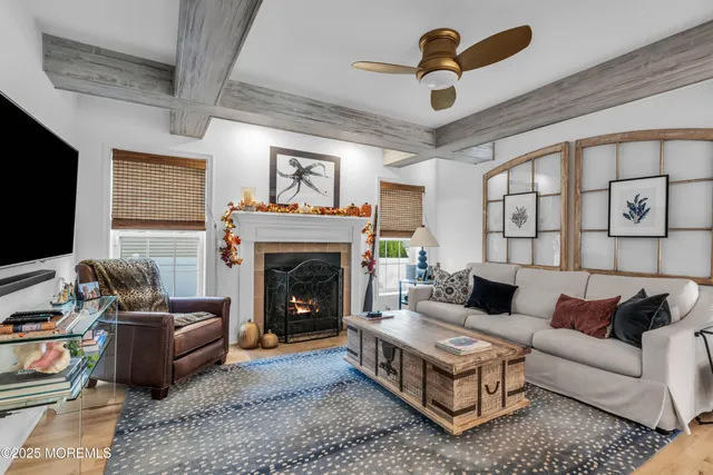 a living room with furniture flat screen tv and a fireplace