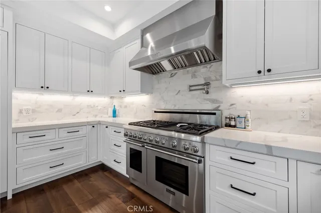 a kitchen with stainless steel appliances a stove sink and cabinets