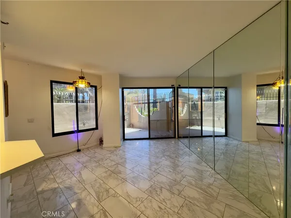 a view of an empty room with glass door