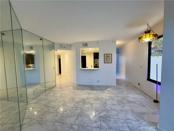 a view of a hallway with bathroom