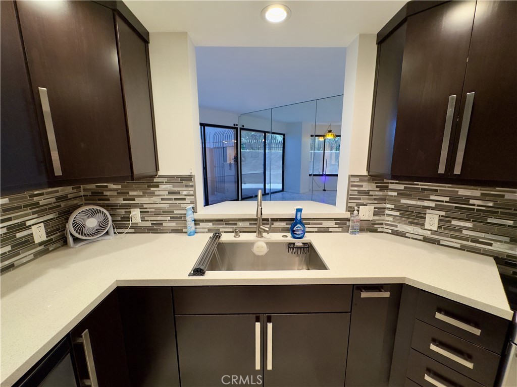 1310 East Ocean Boulevard, Unit 101 Long Beach, CA 90802 - Photo 17 of 29 a kitchen with a sink and cabinets