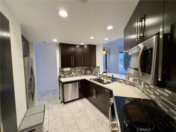 a kitchen with lots of counter top space and refrigerator