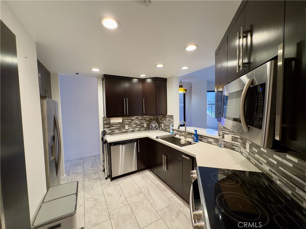 1310 East Ocean Boulevard, Unit 101 Long Beach, CA 90802 - Photo 18 of 29 a kitchen with lots of counter top space and refrigerator