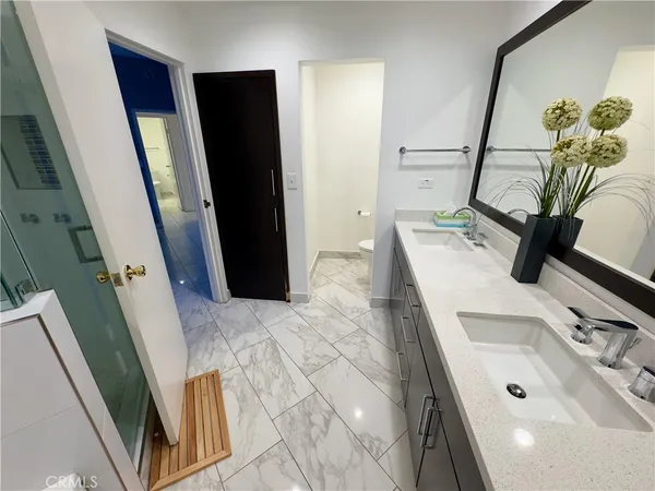 a bathroom with a sink a mirror and a shower