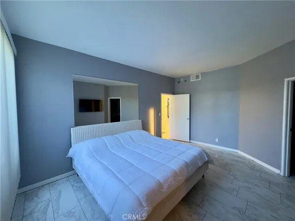 a bedroom with a bed and window