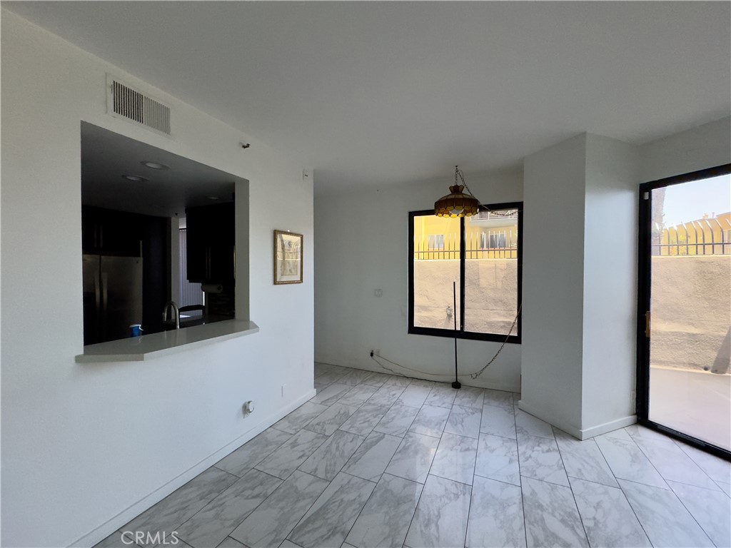 1310 East Ocean Boulevard, Unit 101 Long Beach, CA 90802 - Photo 5 of 29 a view of an empty room with window and wooden floor