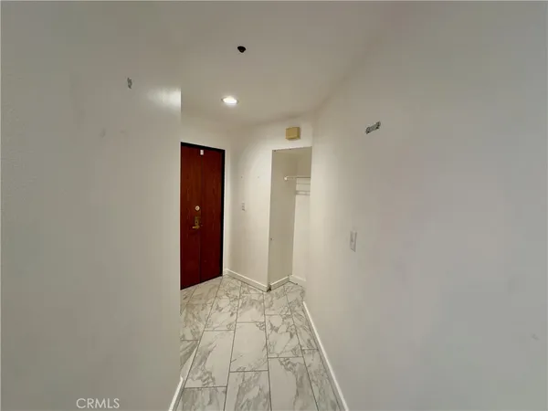 a view of hallway with wooden floor