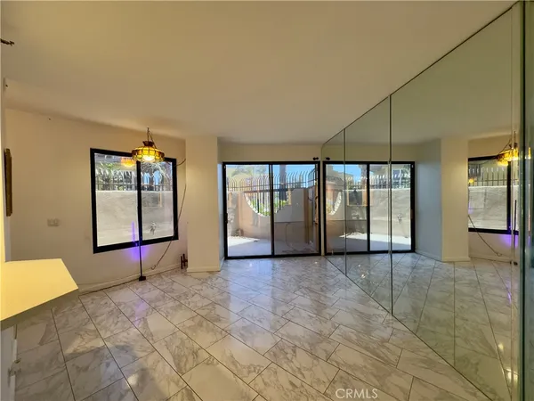 a view of an empty room with glass door