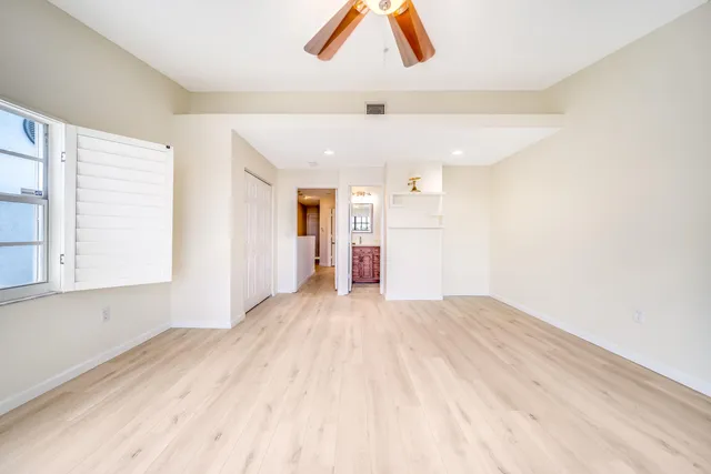 a view of empty room with wooden floor