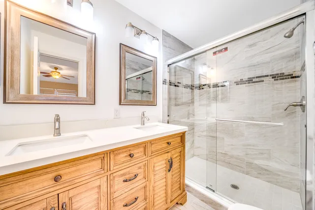a bathroom with a shower sink and mirror