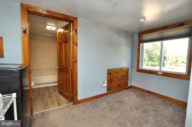 an empty room with windows and entrance