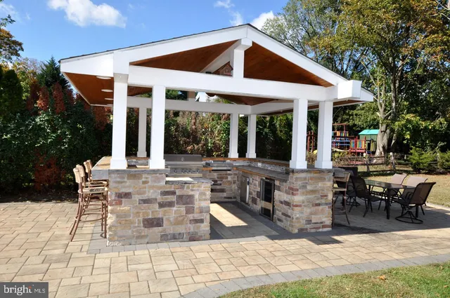 a view of a house with sitting area and garden
