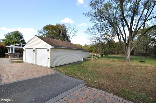 a view of a house with a yard and garage