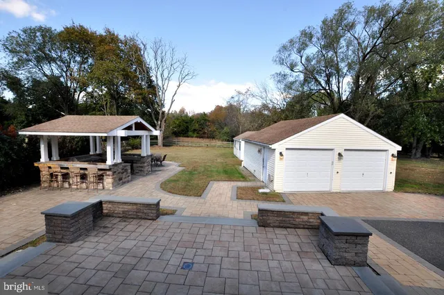 a view of house with swimming pool and sitting area