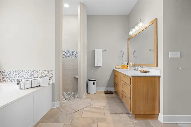 a spacious bathroom with a double vanity sink and a mirror