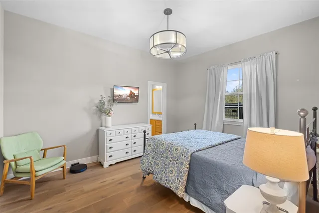 a bedroom with a bed window and table