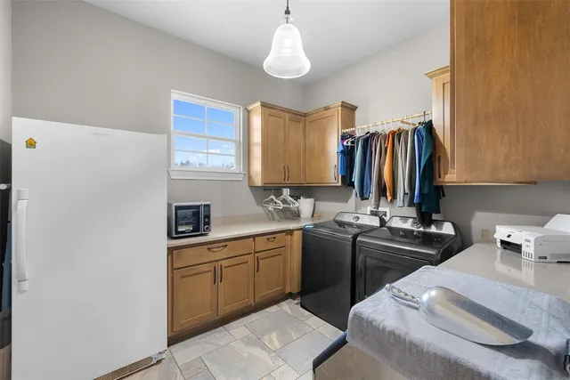 a kitchen with a sink appliances and cabinets