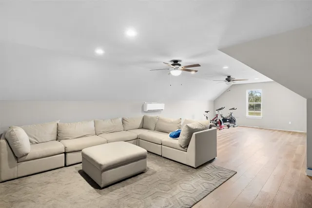 a living room with furniture and a wooden floor